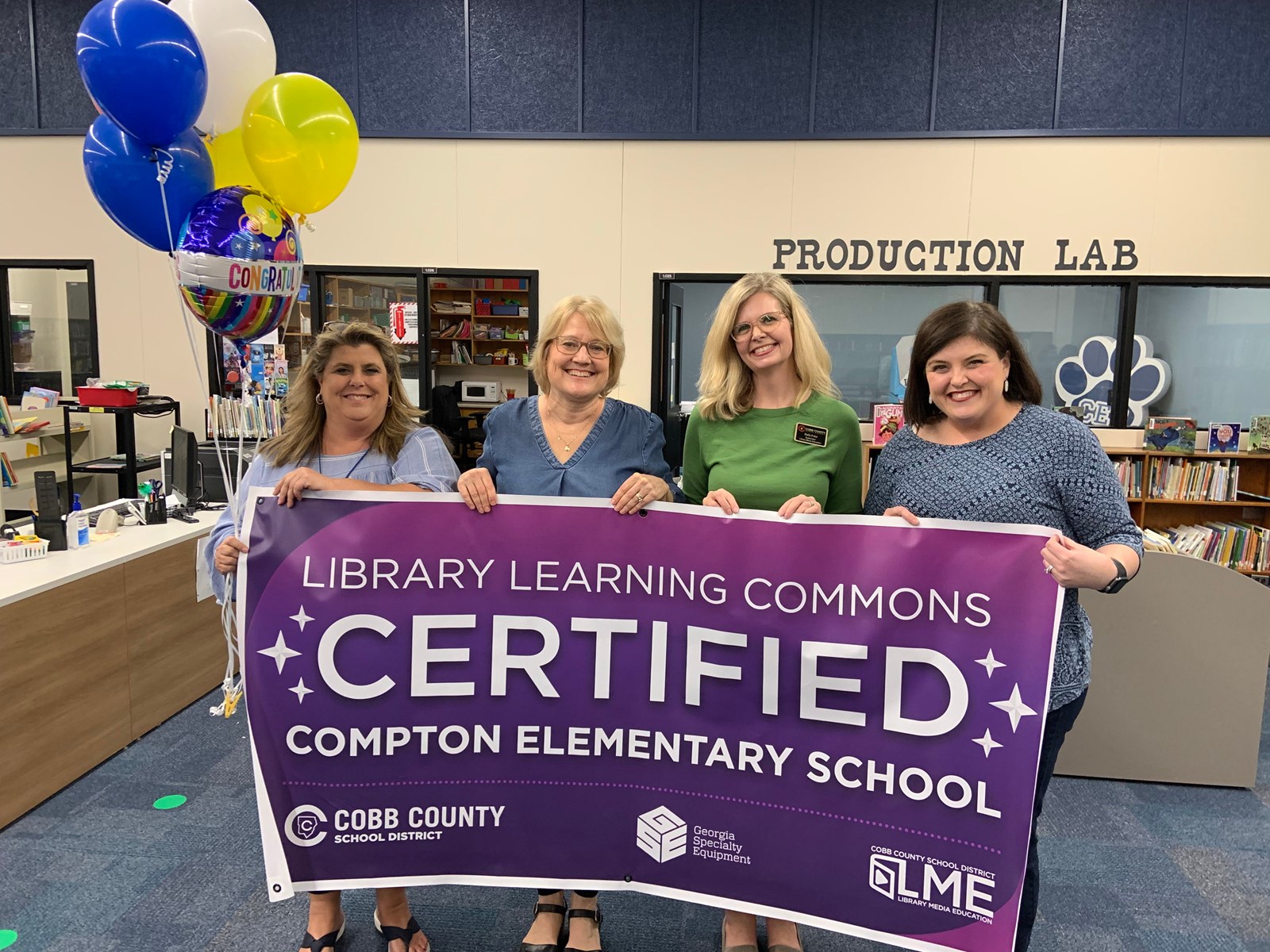 Compton Staff holding Library Learning Commons Sign