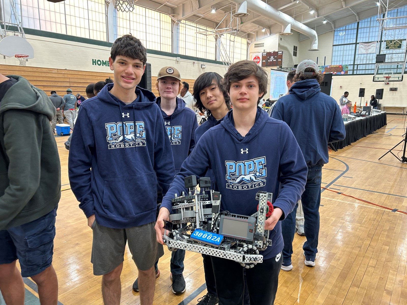 Pope robotics team members with robot