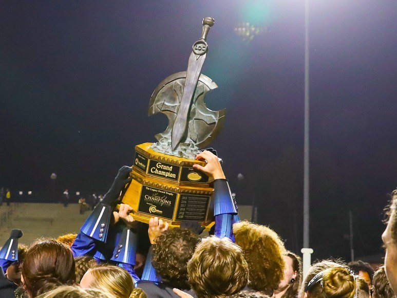 marching band trophy with hands