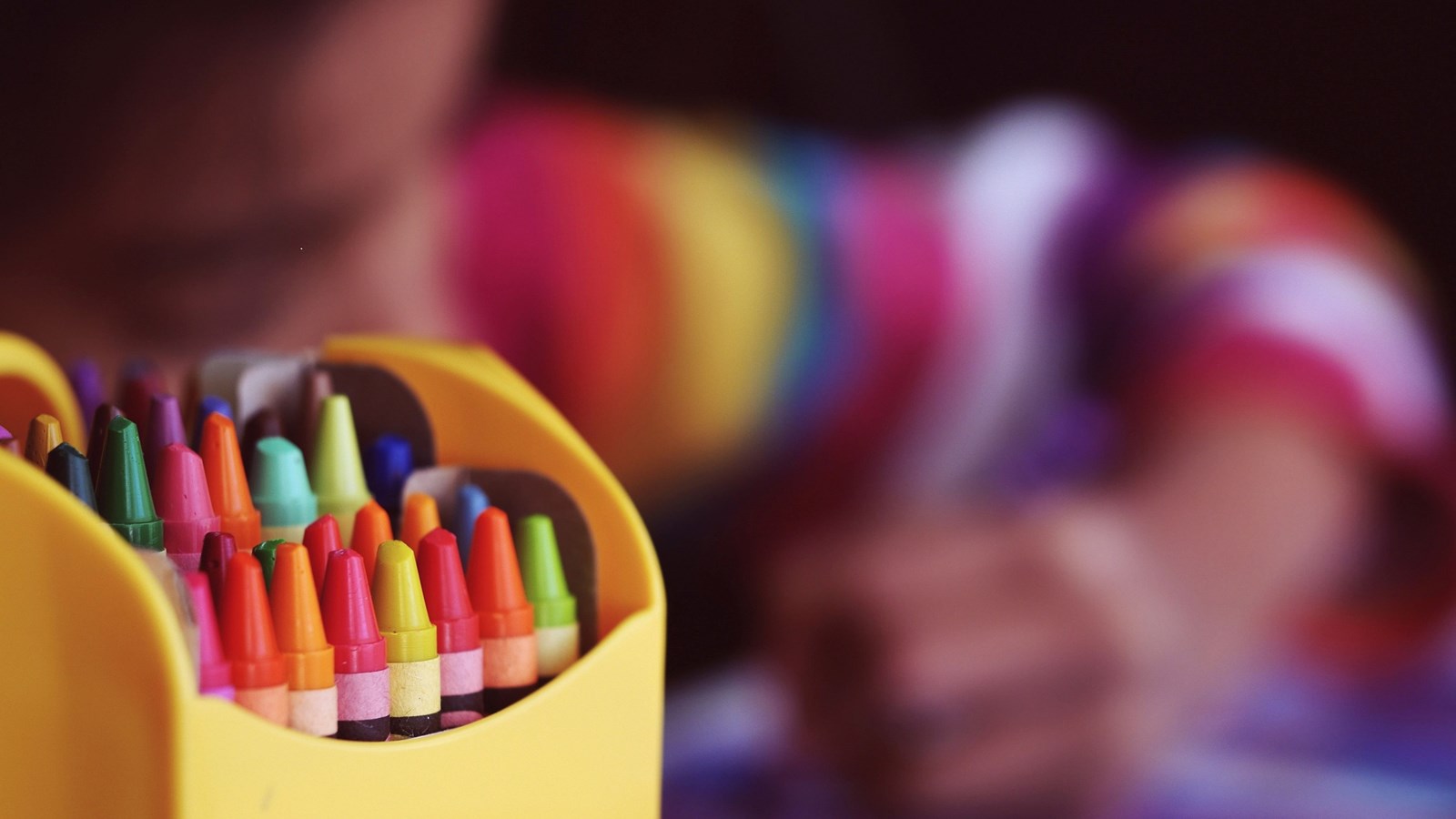 crayons and student in background