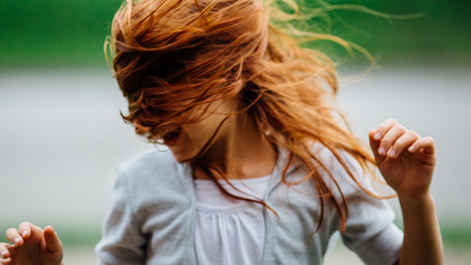 redheaded girl dancing in wind