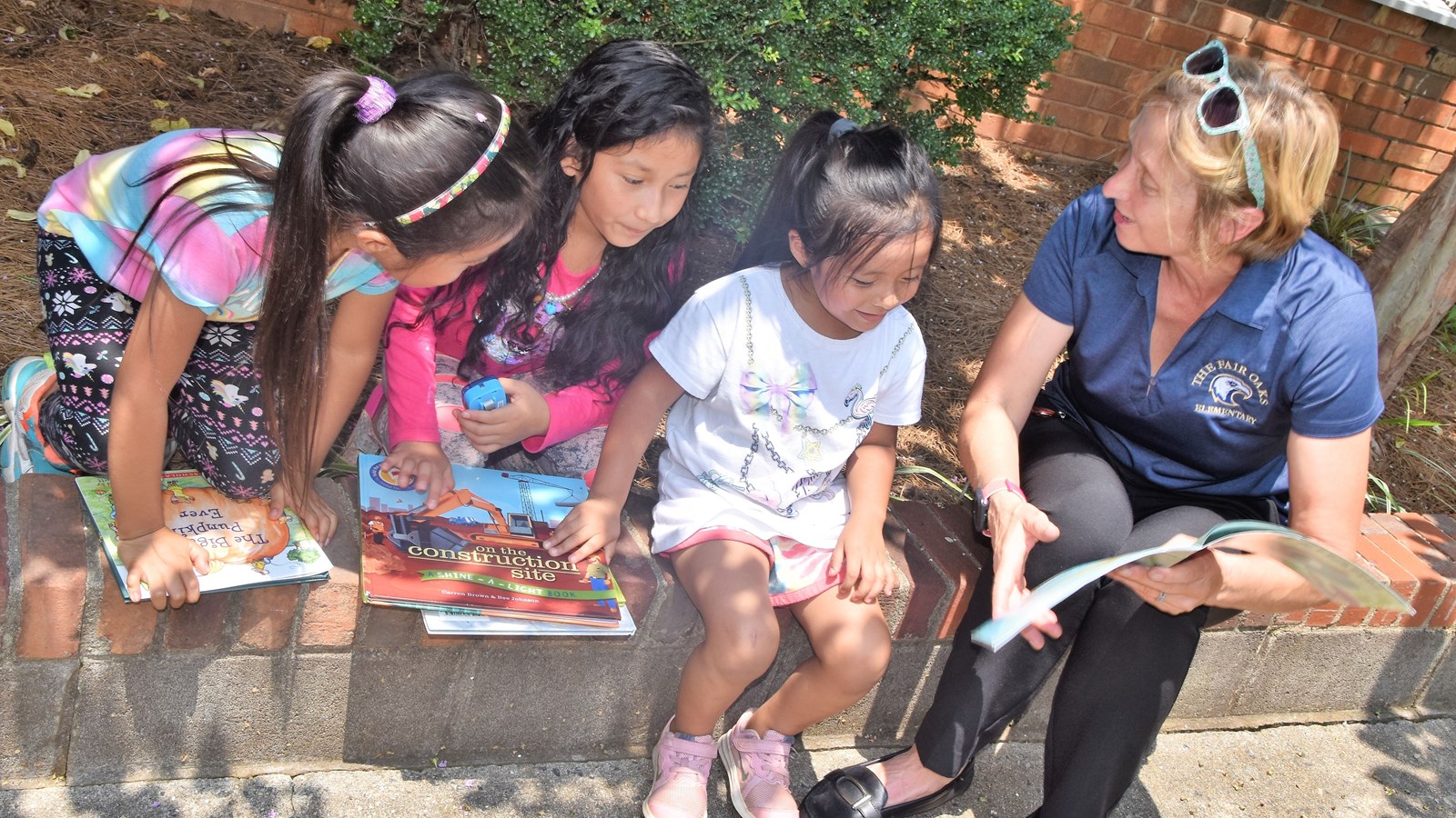 Cobb children read books from the Little Free Library