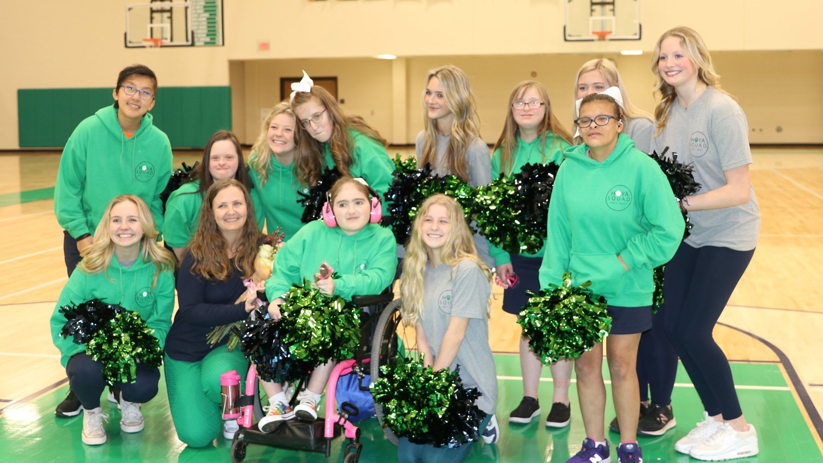 Harrison Cheerleaders and the Hoya Squad celebrate their Coach Melissa Churchill.