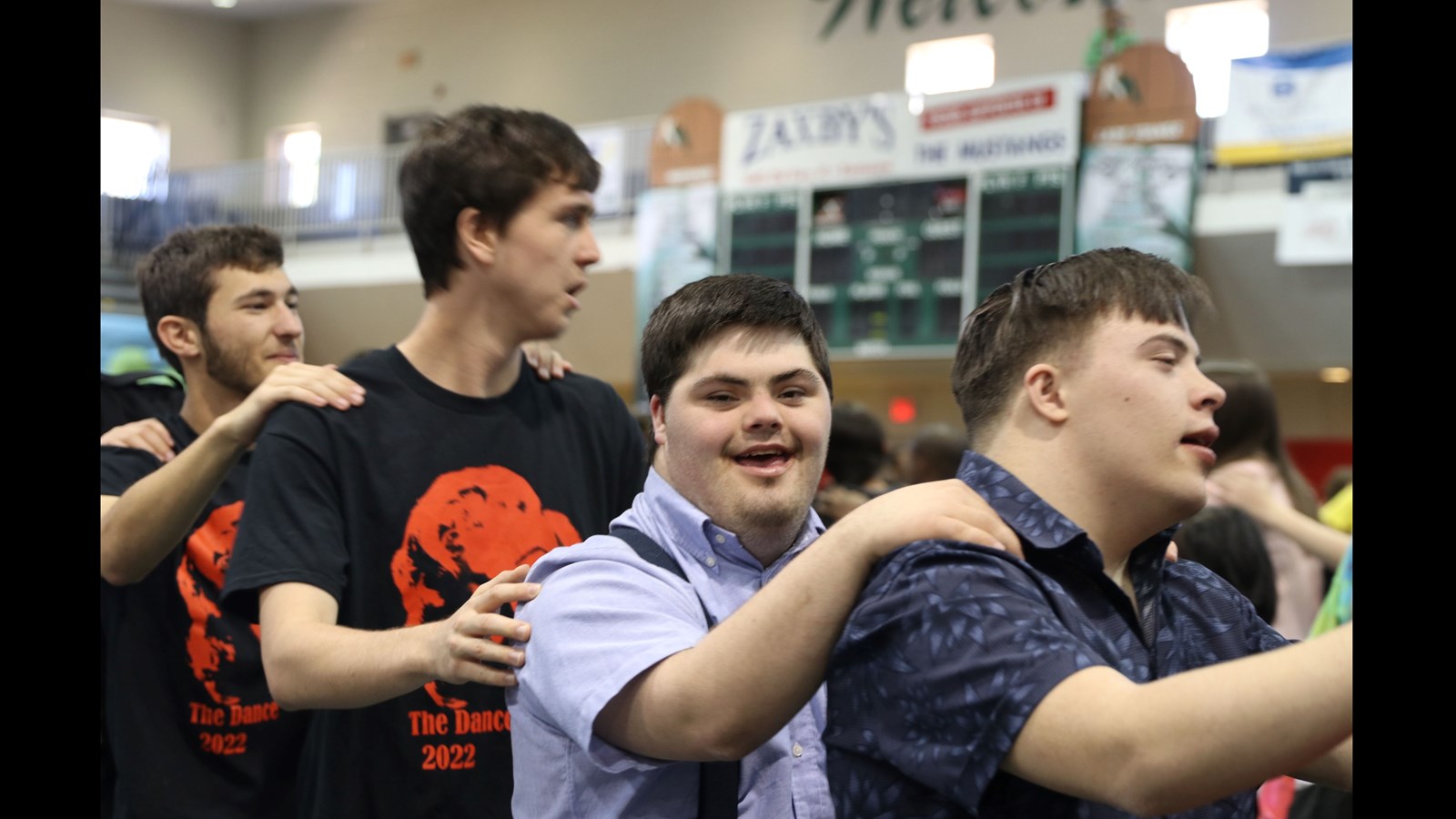 Kennesaw Mountain High School student volunteers dance and interact with their guests at the school’s annual dance for students with special needs.